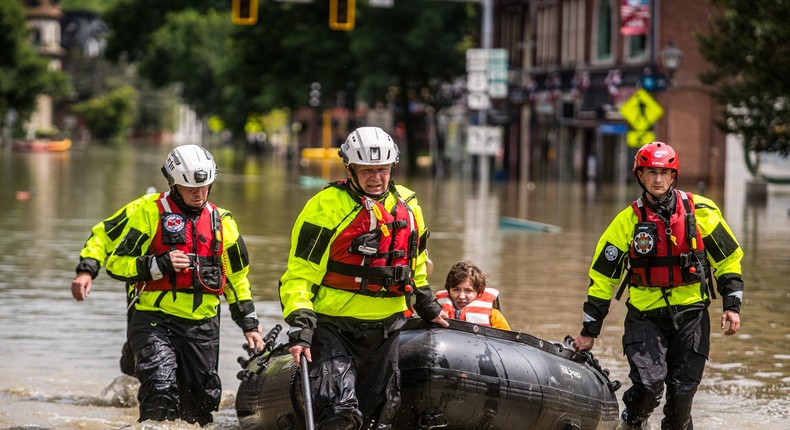 Members of the Colchester Technical Team rescue residents through flooded street of downtown Montpelier, Vermont, on Tuesday.John Tully for The Washington Post via Getty Images