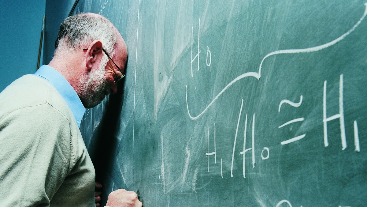 Portrait of a Frustrated Maths Lecturer Banging his Head Against a Blackboard