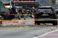 Evidence markers are seen on street around security officials near site of explosion in New York