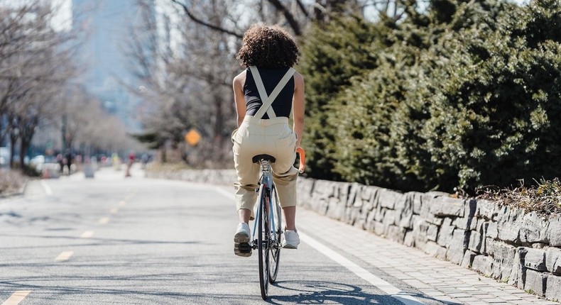 Cyclist riding bicycle on a city street [Photo: Blue Bird]