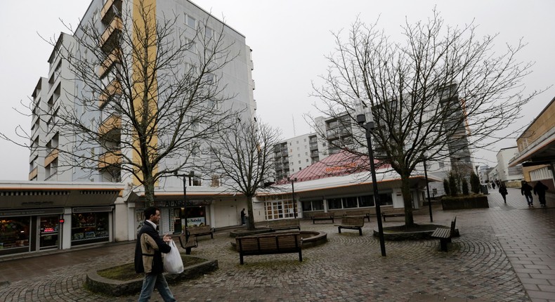 A man walks in the centre of the Husby suburb of Stockholm April 7, 2014.