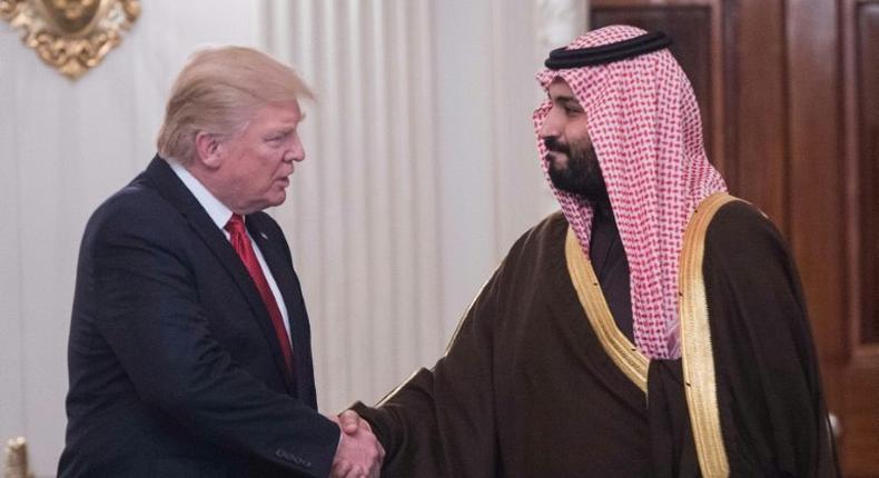 US President Donald Trump and Saudi Deputy Crown Prince and Defense Minister Mohammed bin Salman shake hands in the State Dining Room before lunch at the White House in Washington, DC, on March 14, 2017