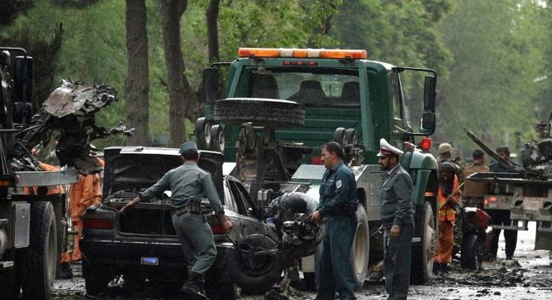 Afghan security personnel investigate the site of a suicide attack that targeted a foreign forces convoy near the US embassy in Kabul on May 3, 2017