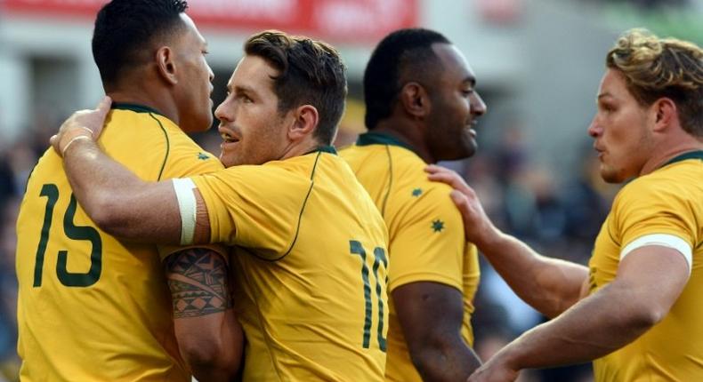 Australia's Israel Folau is congratulated by teammates after successful try during their rugby union Test match against Fiji, in Melbourne, on June 10, 2017