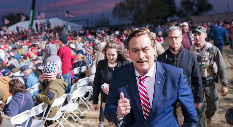 Mike Lindell, the CEO of MyPillow, walks past a crowd of supporters during a rally for former President Donald Trump in Florence, Ariz., on January 15, 2022.