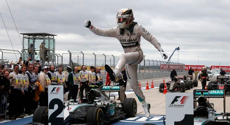 Mercedes Formula One driver Lewis Hamilton of Britain leaps off of his car after winning the U.S. F1 Grand Prix at the Circuit of The Americas in Austin, Texas October 25, 2015. REUTERS/Adrees Latif