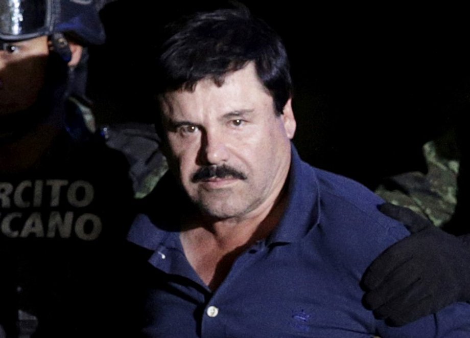 Recaptured drug lord Joaquin "El Chapo" Guzman is escorted by soldiers at the hangar belonging to the Mexican attorney general in Mexico City, January 2016.