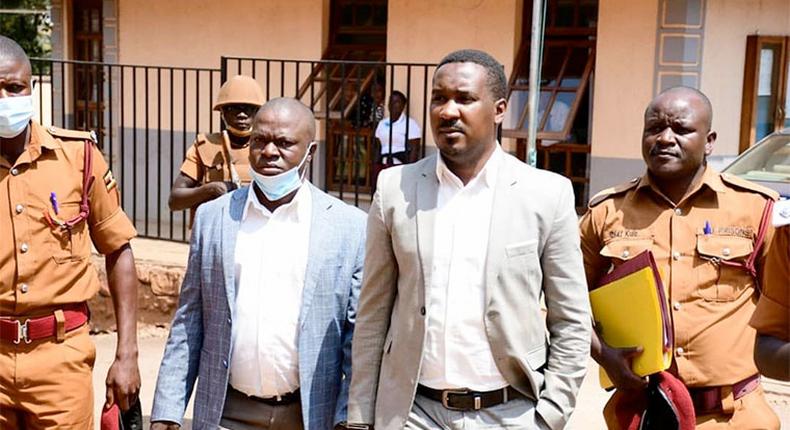 Muhammad-Ssegirinya (L) and Allan Ssewanyana in plainclothes 