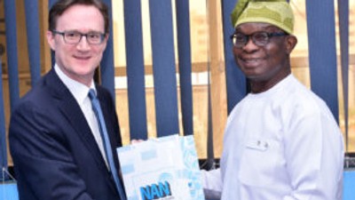 Managing Director of the News Agency of Nigeria (NAN), Buki Ponle (r) offering a souvenir of the agency to the new British High Commissioner to Nigeria, Mr Richard Montgomery (l) when the latter paid a courtesy call on the NAN MD in Abuja on Thursday, June 22, 2023. NAN Photo.