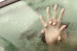 Couple holding hands having sex inside a car