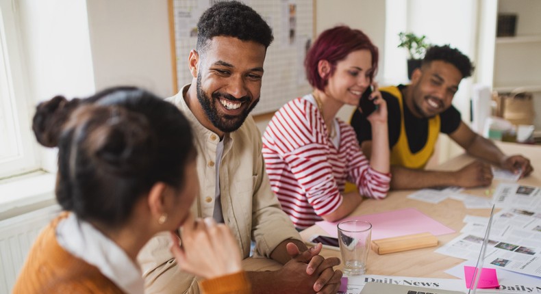 A group of people sitting at the desk at work, brainstorming.Halfpoint Images/Getty Images