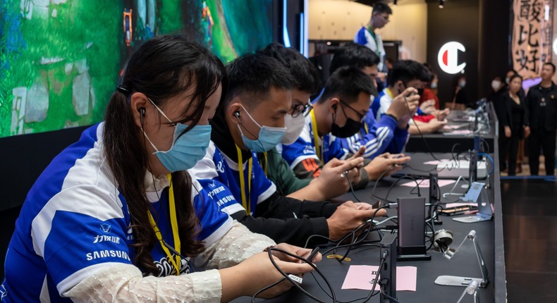 Players compete in an online mobile game 'Arena of Valor' during the 2021 G-Power e-sports competition at a shopping mall on October 22, 2021 in Shanghai, China.