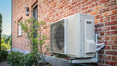 Electric heat pumps are energy efficient and don't burn fossil fuels.Nancy Pauwels/Getty Images.