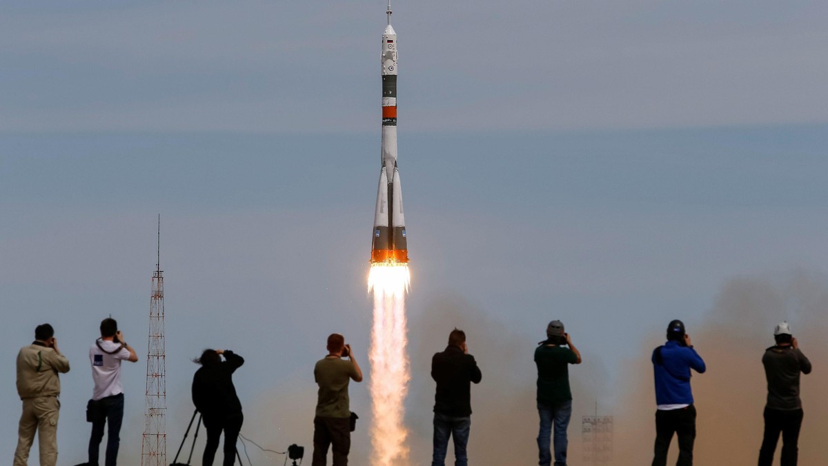 Photographers take pictures as Soyuz MS-04 spacecraft carrying the crew of Fischer of the U.S. and Yurchikhin of Russia as it blasts off to ISS from the launchpad at the Baikonur Cosmodrome