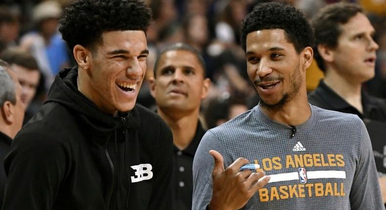 Lonzo Ball (L) and Josh Hart of the Los Angeles Lakers watch teammates warm up before the championship game of the 2017 Summer League against the Portland Trail Blazers, at the Thomas & Mack Center in Las Vegas, Nevada, on July 17