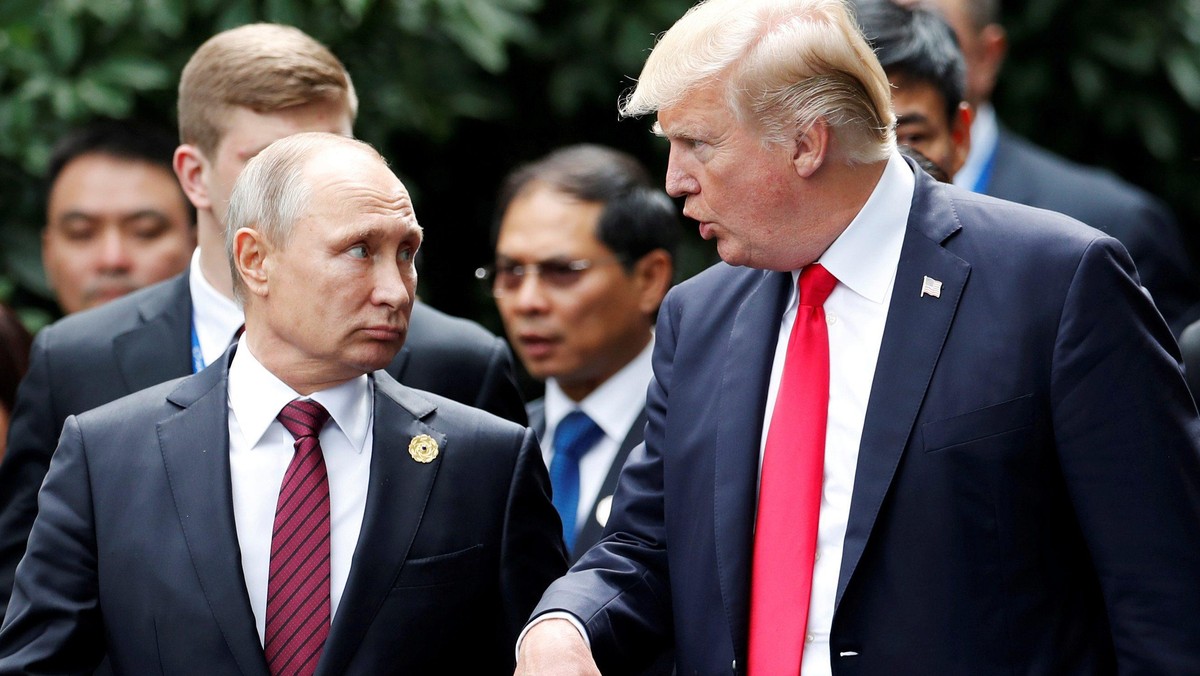 FILE PHOTO: U.S. President Donald Trump and Russia's President Vladimir Putin talk during the family