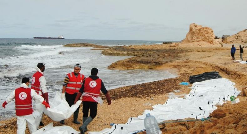 Libyan Red Crescent volunteers recovering the bodies of 74 migrants that washed ashore on February 20 near Zawiyah on Libya’s northern coast on February 21, 2017