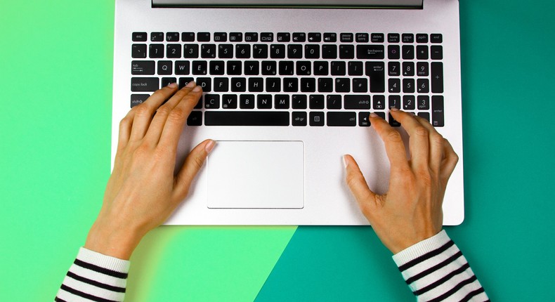 Woman using Apple Mac laptop over colorful background