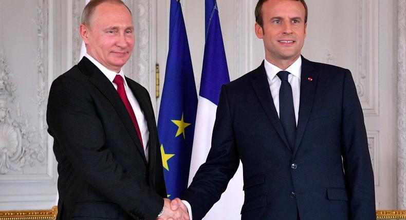 French President Emmanuel Macron with Russian President Vladimir Putin.