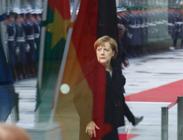 German Chancellor Merkel waits for the arrival of welcomes Burkina Faso President Roch Marc Christia