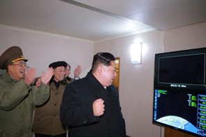 North Korea's leader Kim Jong Un is seen as the newly developed intercontinental ballistic rocket Hw