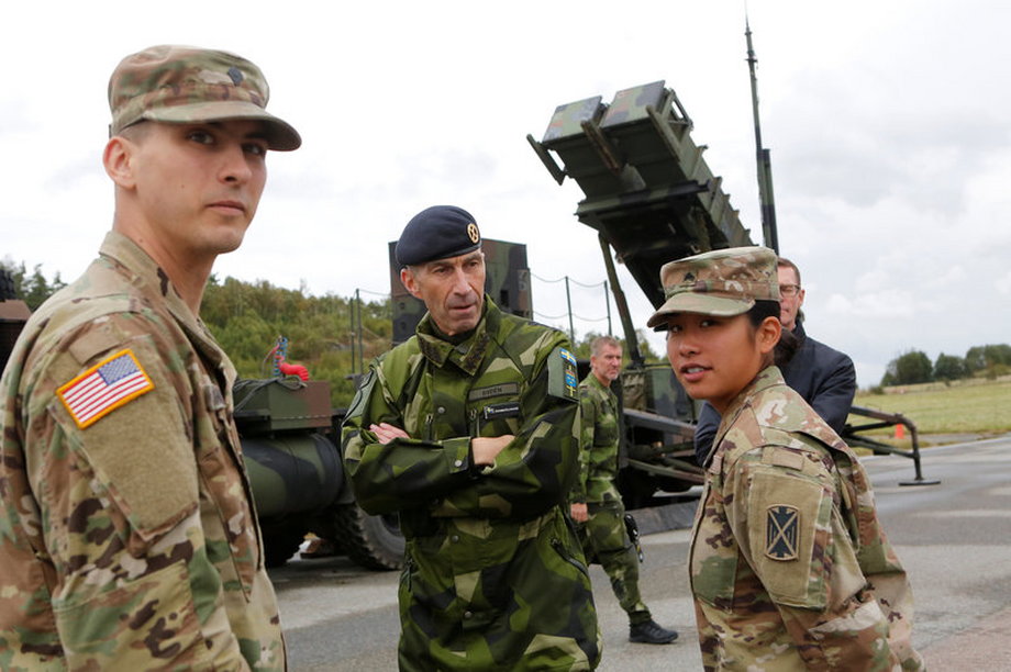 Micael Byden, the supreme commander of the Swedish armed forces, with US soldiers during a NATO exercise at Save airfield in Goteborg, Sweden, September 13, 2017.