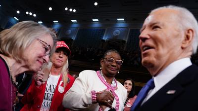 Republican Rep. Marjorie Taylor Greene, left,  looks on as President Joe Biden, right, arrives to the House Chamber of the US Capitol for his third State of the Union address to a joint session of Congress in Washington, DC, on March 7, 2024.Shawn Thew/pool/AFP/Getty Images