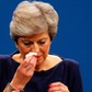 Britain's Prime Minister Theresa May wipes her nose after she suffered a coughing fit whilst addressing the Conservative Party conference in Manchester