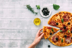 colorful tasty pizza. woman taking piece of italian pizza