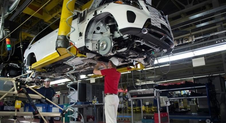 An employee installs parts on the undercarriage of a Mercedes-Benz GLS-Class SUV at the Mercedes-Benz US International factory in Vance, Alabama on June 8, 2017.