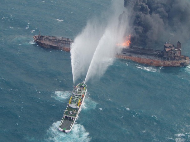 A rescue ship works to extinguish the fire on the stricken Iranian oil tanker Sanchi in the East Chi