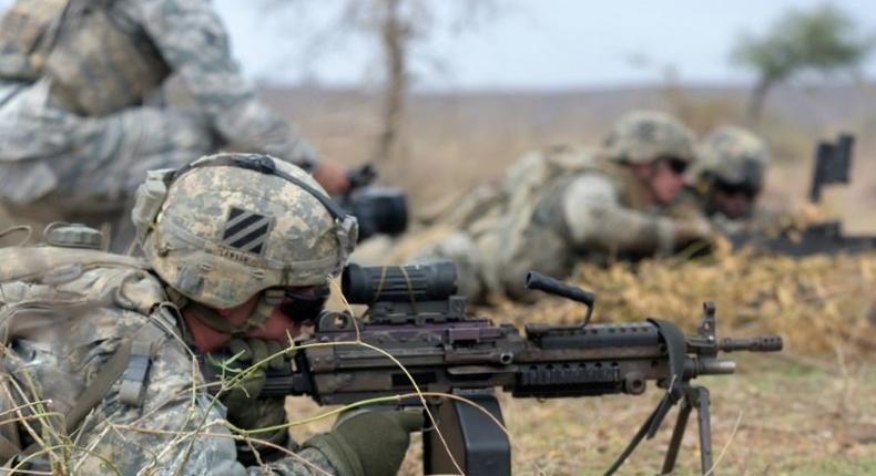 American soldiers of 1st Battalion, 30th Infantry Regiment, 2nd Infantry Brigade Combat Team, 3rd Infantry Division deploy during a combined training exercise with Senegalese 1st Paratrooper Battalion in Thies on July 25, 2016 