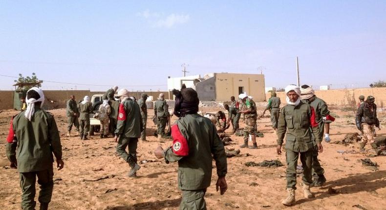 Soldiers attend to wounded and casualties following a suicide bomb attack in Gao, northern Mali on January 18, 2017