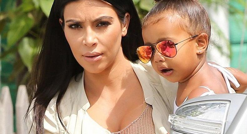 Kim Kardashian carrying her daughter, North West