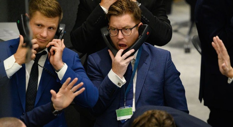 Traders, brokers and clerks shout and gesture on the first day of in-person trading at the London Metal Exchange