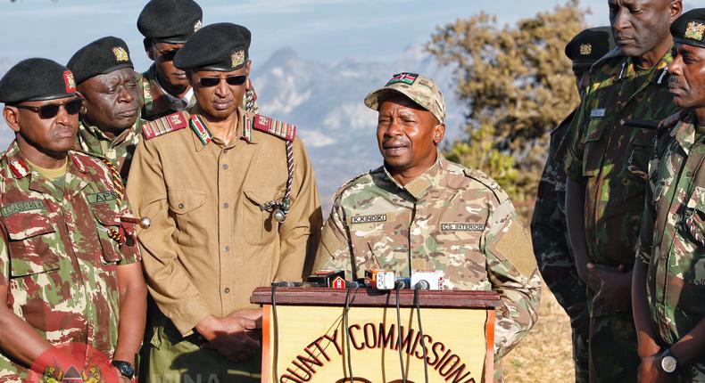 Interior CS Kithure Kindiki addressing the media while flanked by security bosses