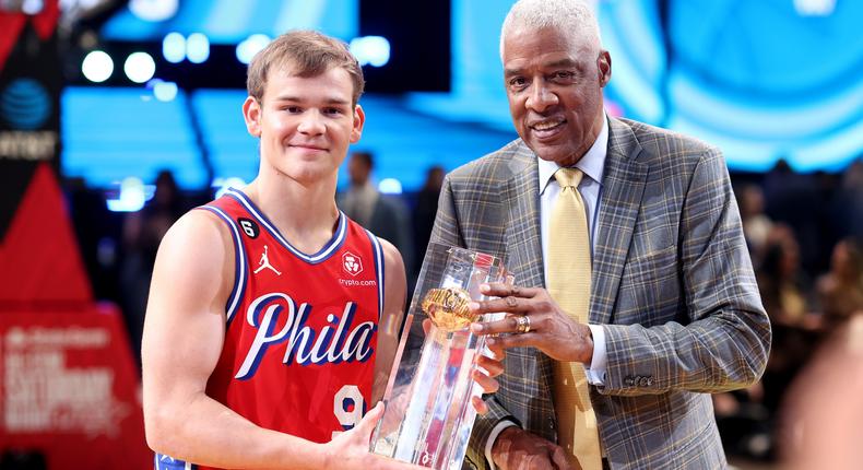 Mac McClung (L) and Julius Erving (R) pose with the NBA Slam Dunk Contest trophy after McClung's victory on February 18, 2023, in Salt Lake City, Utah.Tim Nwachukwu/Getty Images