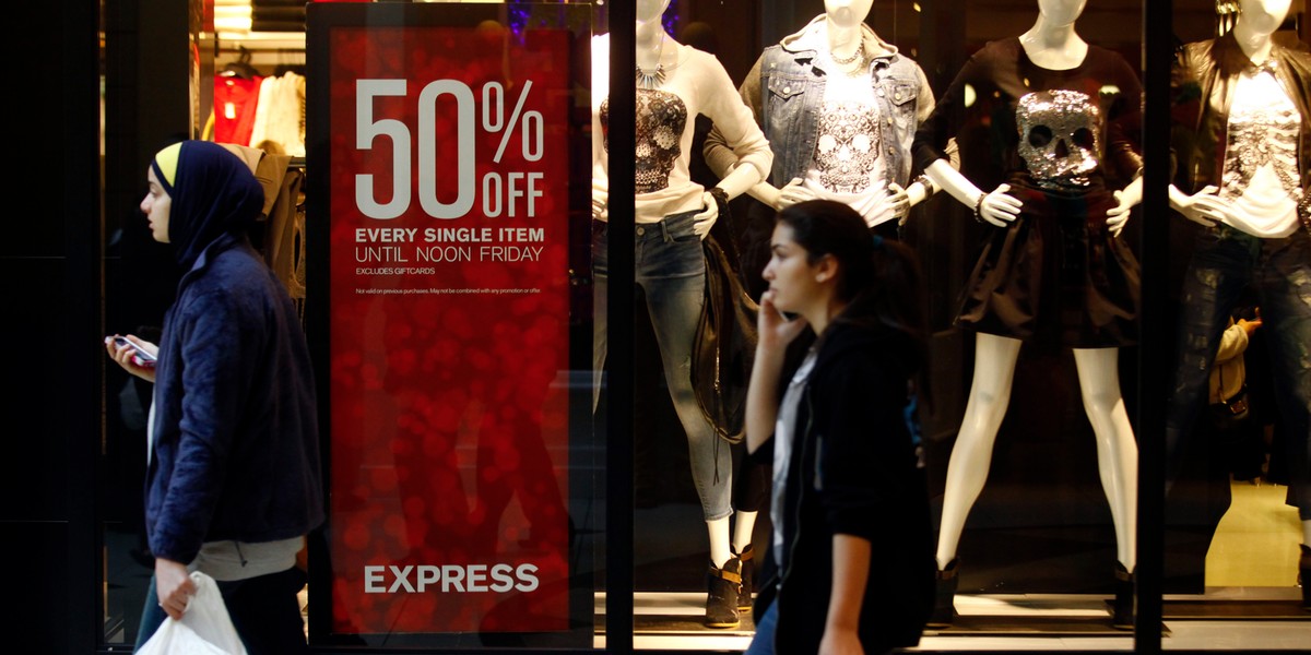 Shoppers walk past a retail shop at Somerset Collection shopping mall in Troy, Michigan.