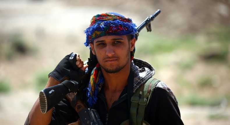 A Syrian Democratic Forces fighter in the Islamic State group's Syrian bastion of Raqa after seizing the Al-Romaniya area on June 11, 2017