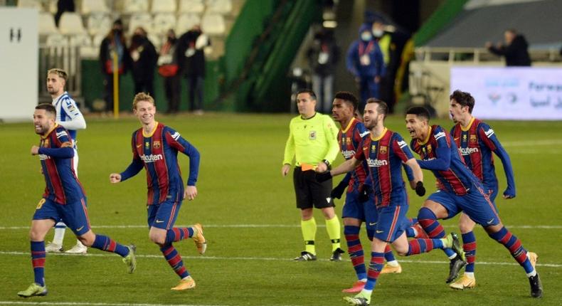 Barcelona celebrate their penalty shootout win over Real Sociedad in the semi-finals of the Spanish Super Cup