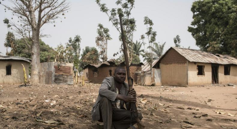 A vigilante clutches his weapon in the village of Bakin Kogi, in Kaduna state, northwest Nigeria -- a region that has long been a centre of unrest fuelled by ethnic and religious tensions