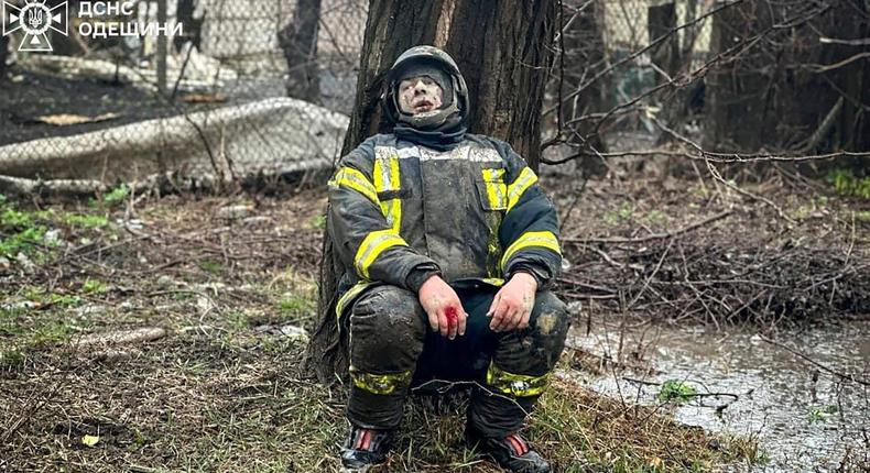 In this photo provided by the Ukrainian Emergency Service, an emergency serviceman sits shocked after a Russian attack in Odesa, Ukraine, Friday, March 15, 2024.Ukrainian Emergency Service via AP