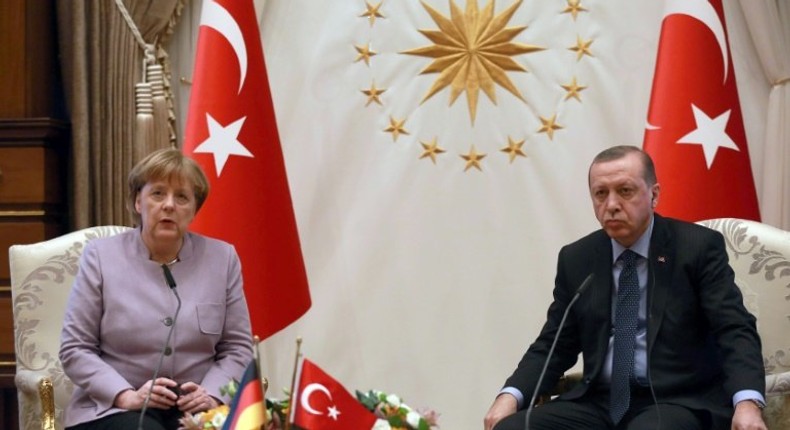 Turkish President Recep Tayyip Erdogan (R) listens on as German Chancellor Angela Merkel speaks during their meeting at the Presidential Palace in Ankara on February 2, 2017