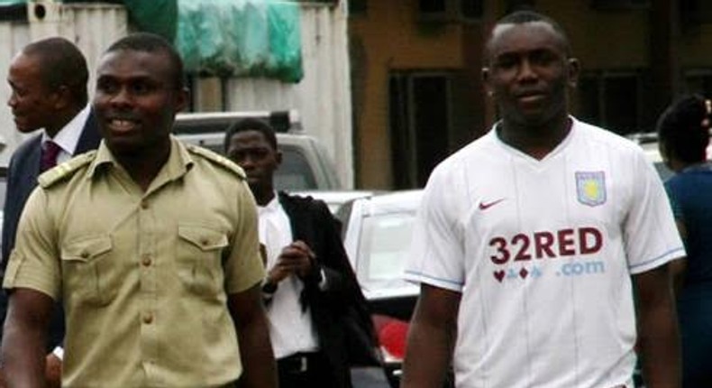 Tobechukwu Igbokwe with a prison guard