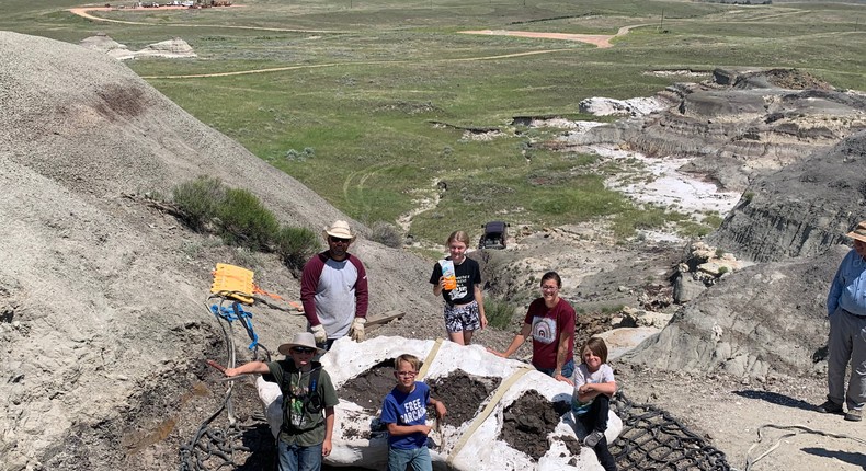 The family who found the fossils at the North Dakota site where Teen Rex was found, posing with the field jacket that contains the fossil.Dr. Tyler R. Lyson/Denver Museum of Nature & Science