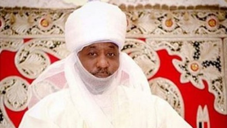 The Emir of Kano is seen holding his grand-daughter.