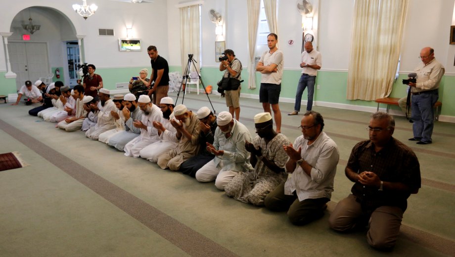 Worshippers listen as Rahman offers a prayer for victims of the Orlando shooting in Fort Pierce, Florida, on June 12.