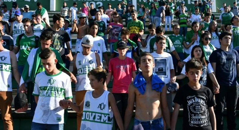 People pay tribute to the players of Brazilian team Chapecoense Real who were killed in a plane accident in the Colombian mountains, at the club's Arena Conda stadium in Chapeco, in the southern Brazilian state of Santa Catarina, on November 29, 2016