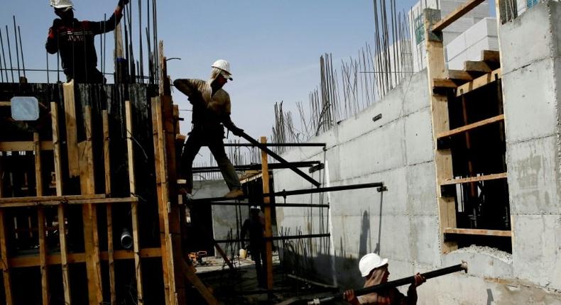 Palestinian laborers work on a construction site in Ramat Shlomo, a Jewish settlement in the mainly Palestinian eastern sector of Jerusalem