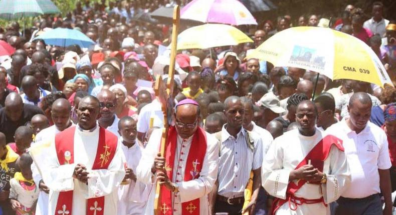 Nyeri Catholic Archbishop Antony Muheria carries a cross as led other faithful in a religious procession to Our Lady of Constanta Cathedral in Nyeri during a past event